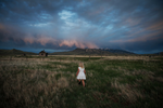 Little girl walking in Wyoming field